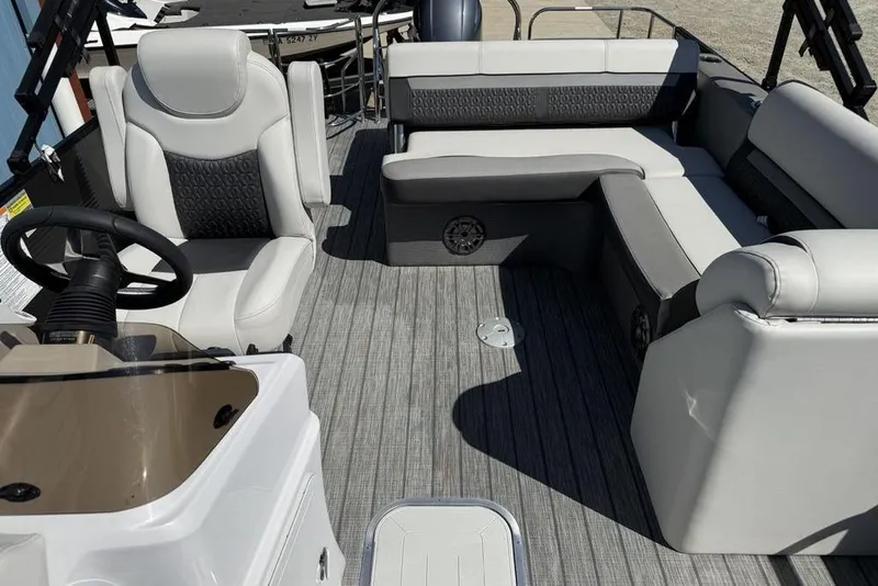 Slide: The Image of Interior of 2021 Godfrey SW 2286 SFL GTP boat with gray seating and steering console. - 11