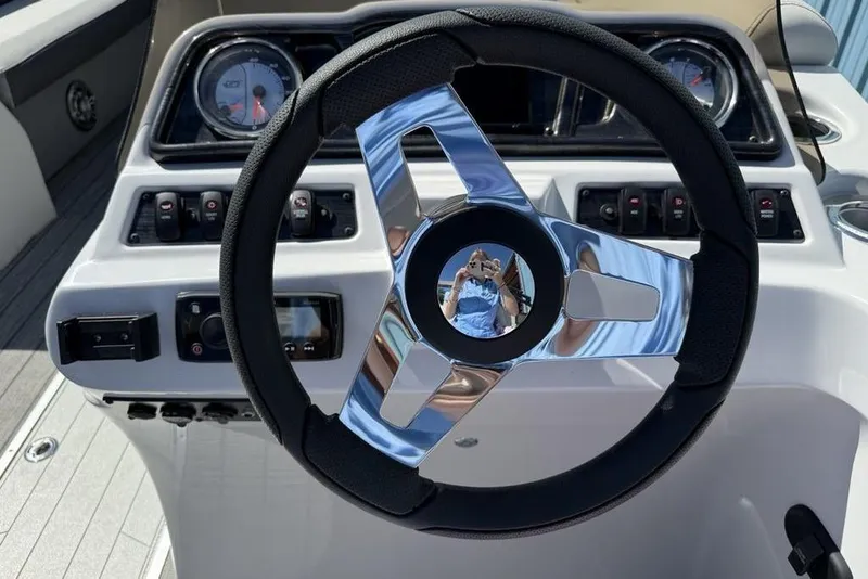 Slide: The Image of Steering wheel of a 2021 Godfrey SW 2286 SFL GTP boat, featuring modern controls. - 13