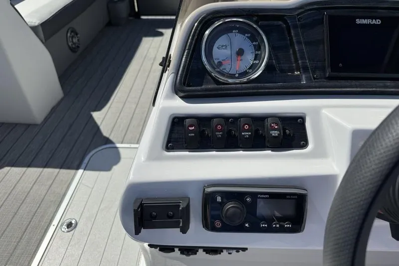 Slide: The Image of Control panel of a 2021 Godfrey SW 2286 SFL GTP boat with switches and gauges. - 14