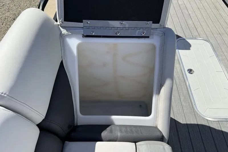 Slide: The Image of Open storage compartment on a 2021 Godfrey SW 2286 SFL GTP boat seat. - 17