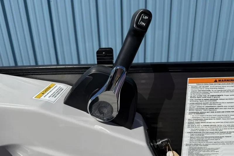 Slide: The Image of Close-up of a 2021 Godfrey SW 2286 SFL GTP boat throttle lever with warning labels. - 20