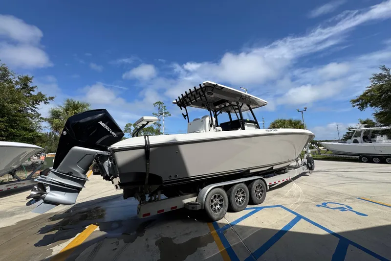 Slide: The Image of 2020 Fountain 38 Tournament Edition boat on trailer under clear blue sky. - 10