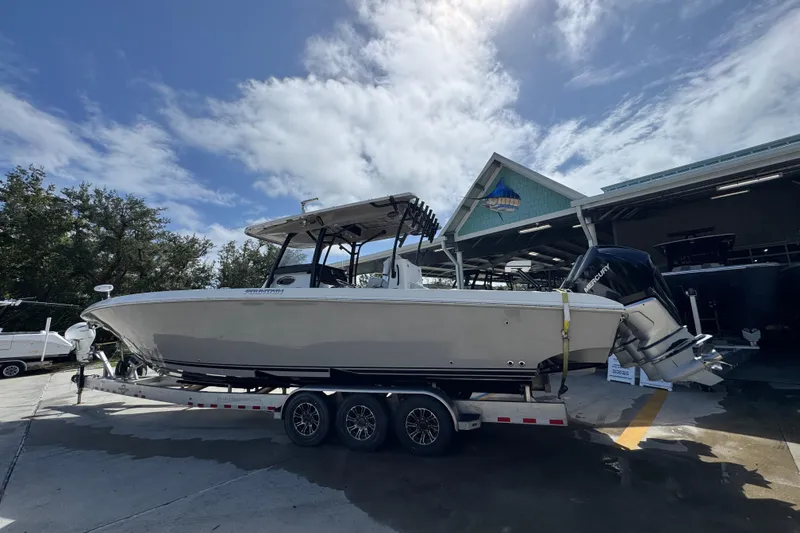 Slide: The Image of 2020 Fountain 38 Tournament Edition boat on trailer, parked outdoors under a partly cloudy sky. - 13