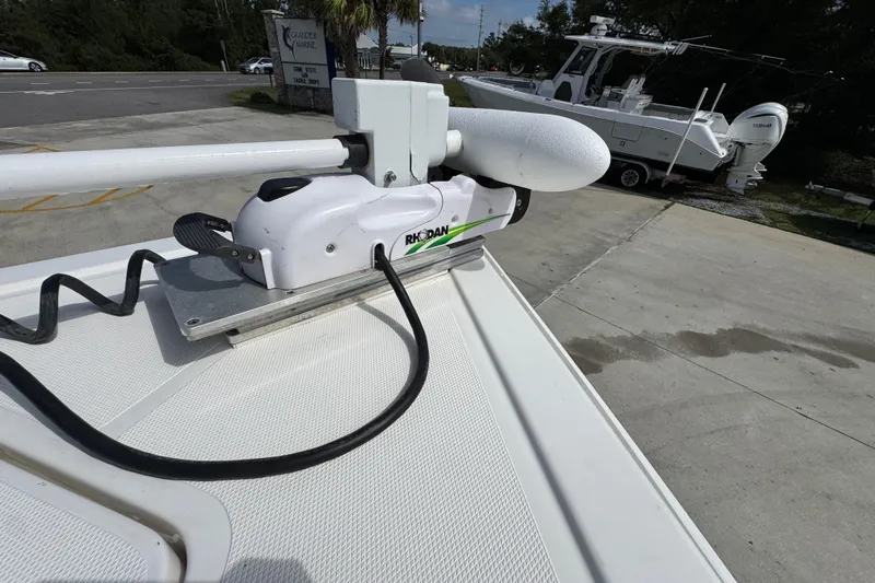 Slide: The Image of Trolling motor on a 2020 Fountain 38 Tournament Edition boat, parked near a marina. - 17