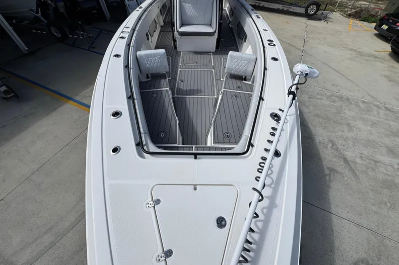 Slide: The Image of 2020 Fountain 38 Tournament Edition boat with spacious deck and seating, docked on concrete. - 18