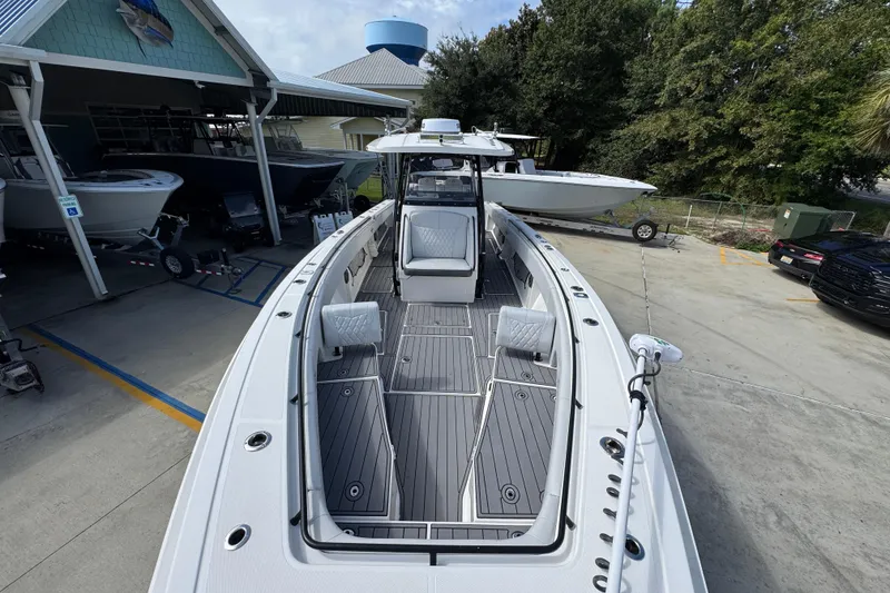 Slide: The Image of 2020 Fountain 38 Tournament Edition boat displayed at a marina with surrounding trees. - 19