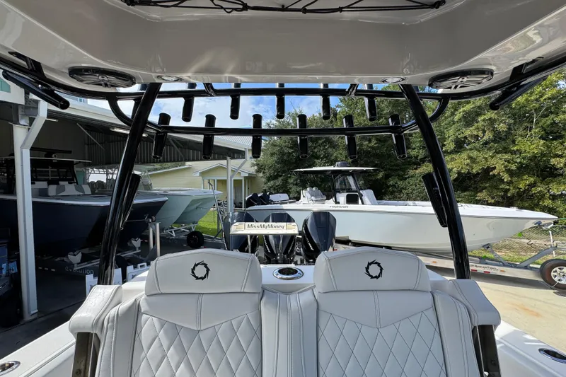 Slide: The Image of 2020 Fountain 38 Tournament Edition boat interior with rod holders and white seating. - 26