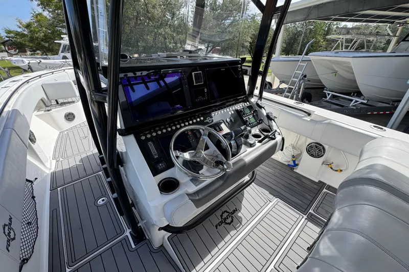 Slide: The Image of 2020 Fountain 38 Tournament Edition boat cockpit with modern controls and steering wheel. - 27