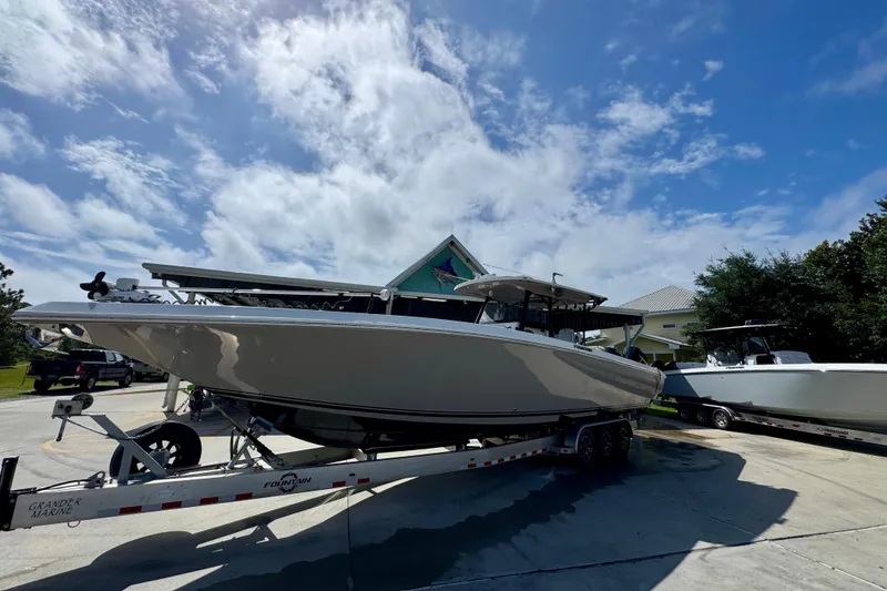Slide: The Image of 2020 Fountain 38 Tournament Edition boat on trailer under blue sky. - 3