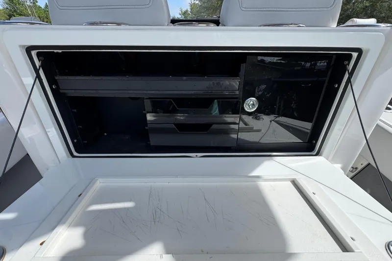 Slide: The Image of Open storage compartment on a 2020 Fountain 38 Tournament Edition boat. - 33