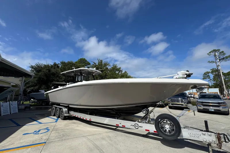 Slide: The Image of 2020 Fountain 38 Tournament Edition boat on trailer under clear blue sky. - 7