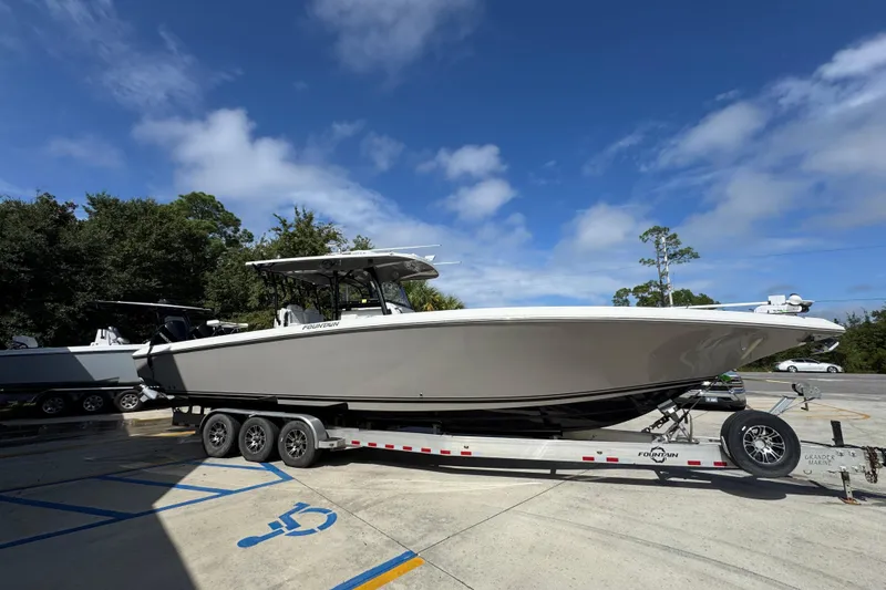 Slide: The Image of 2020 Fountain 38 Tournament Edition boat on trailer under clear blue sky. - 8
