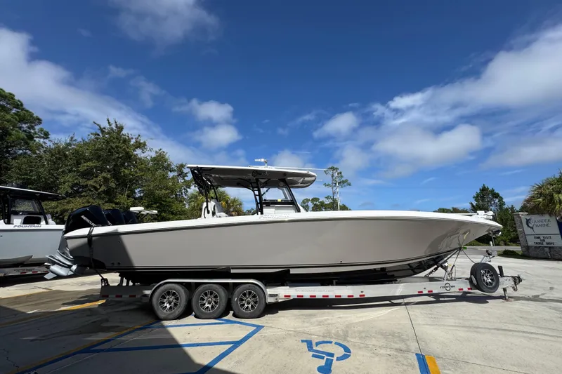 Slide: The Image of 2020 Fountain 38 Tournament Edition boat on trailer under blue sky. - 9