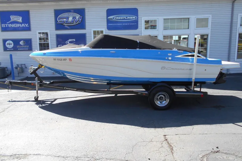 Slide: The Image of 2019 Crownline 205 SS boat on trailer, parked outside dealership. - 11