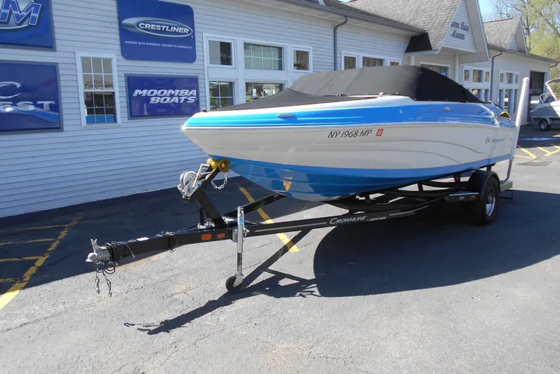 Slide: The Image of 2019 Crownline 205 SS boat on trailer, parked outside a marine dealership. - 12
