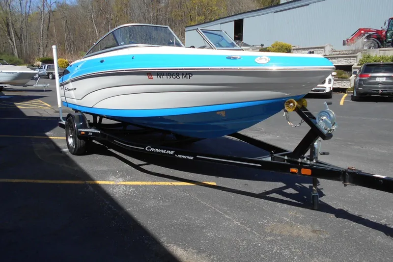 Slide: The Image of 2019 Crownline 205 SS boat on trailer in parking lot. - 3
