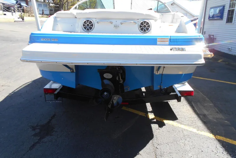 Slide: The Image of 2019 Crownline 205 SS boat rear view, blue and white design, on a trailer. - 5