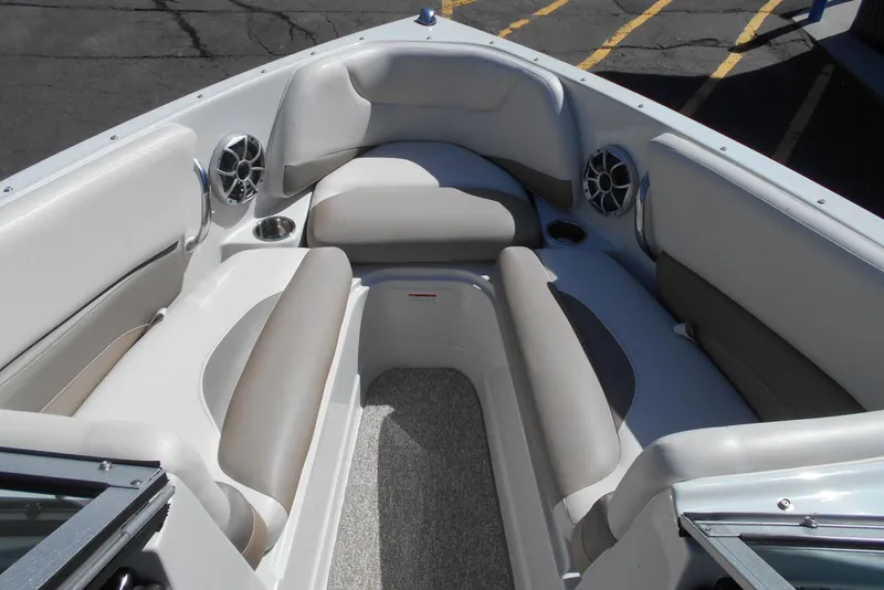 Slide: The Image of 2019 Crownline 205 SS boat interior with cushioned seating and speakers. - 6