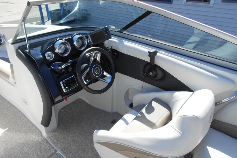 Slide: The Image of Interior of a 2019 Crownline 205 SS boat, featuring a sleek dashboard and steering wheel. - 7