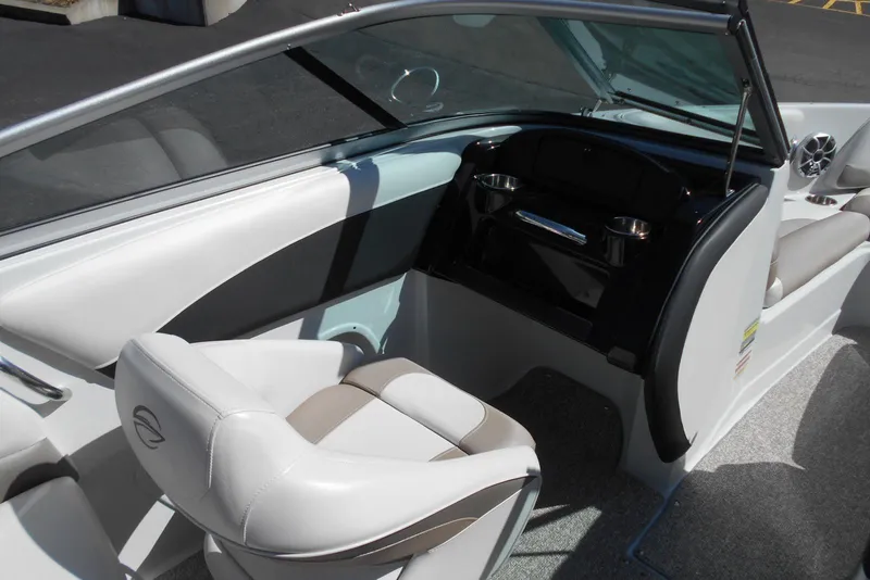 Slide: The Image of 2019 Crownline 205 SS boat interior with white seating and dashboard view. - 8