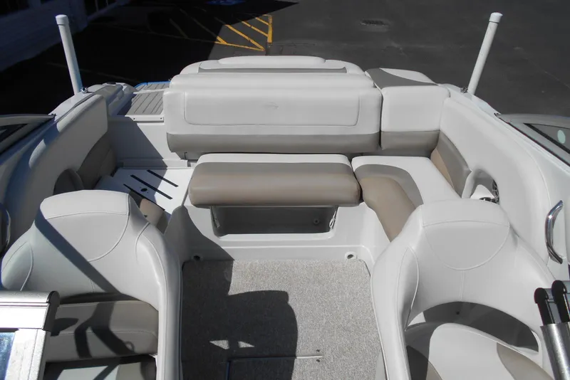 Slide: The Image of 2019 Crownline 205 SS boat interior with white and beige seating arrangement. - 9