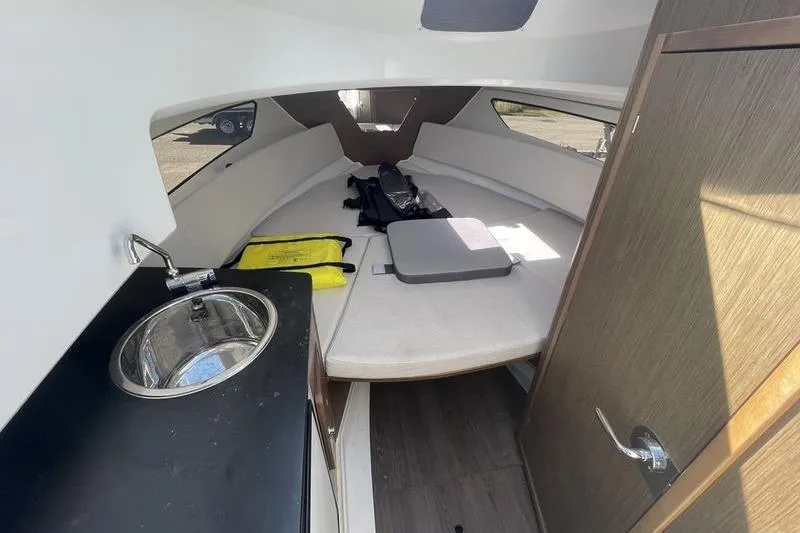 Slide: The Image of Interior of 2022 Jeanneau 7.5 Leader boat with sink and seating area. - 10