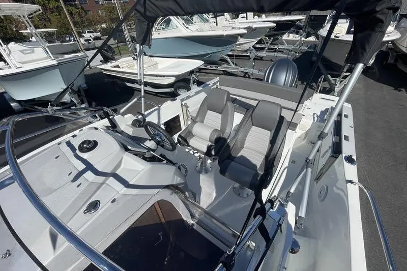 Slide: The Image of 2022 Jeanneau 7.5 Leader boat interior with dual seats and steering wheel. - 11