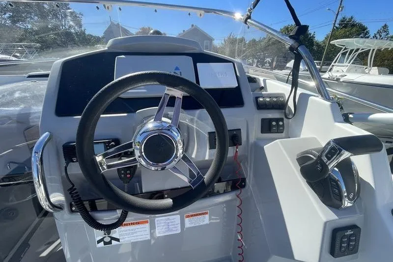 Slide: The Image of Steering console of 2022 Jeanneau 7.5 Leader boat with modern controls and dashboard. - 16