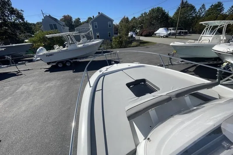 Slide: The Image of 2022 Jeanneau 7.5 Leader boat on display in a sunny outdoor setting. - 4