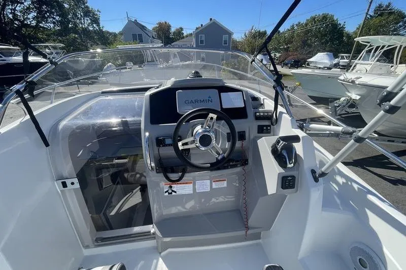 Slide: The Image of 2022 Jeanneau 7.5 Leader boat cockpit with Garmin navigation system and steering wheel. - 8