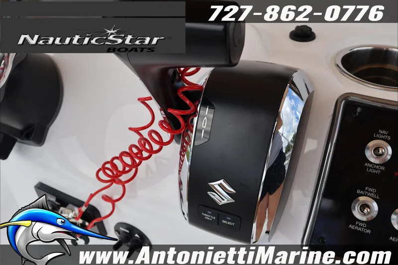 Slide: The Image of Close-up of NauticStar 191 Hybrid 2026 boat controls with Suzuki throttle and red coiled cord. - 13