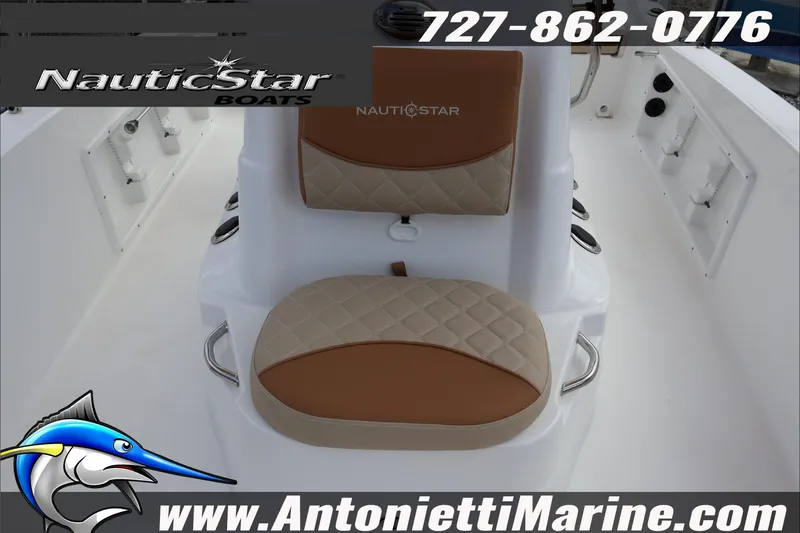 Slide: The Image of 2026 NauticStar 191 Hybrid boat interior with tan seating, logo, and contact details. - 19