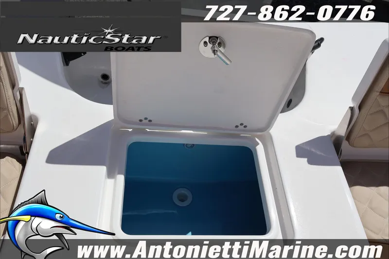 Slide: The Image of 2026 NauticStar 191 Hybrid boat livewell, featuring open lid and blue interior. - 26