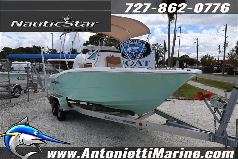 Slide: The Image of 2026 NauticStar 191 Hybrid boat on trailer at Antonietti Marine dealership. - 5