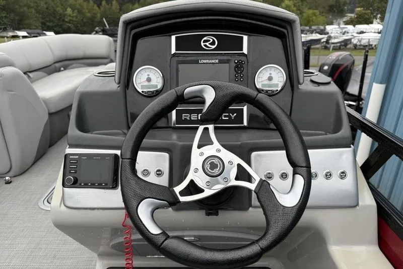 Slide: The Image of 2023 Regency 250 DL3 boat dashboard with steering wheel and gauges. - 10