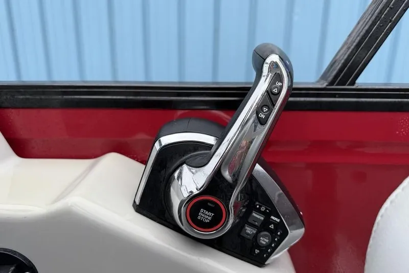 Slide: The Image of Throttle control of 2023 Regency 250 DL3 boat with start/stop button and trim controls. - 14