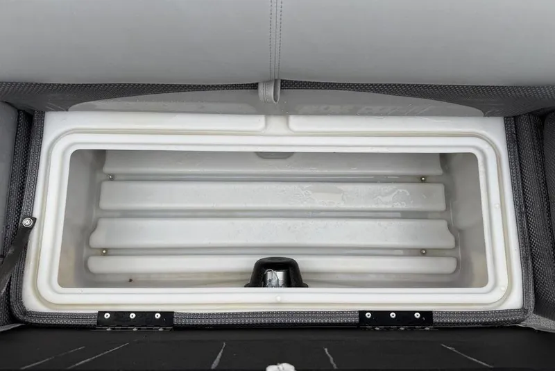 Slide: The Image of Built-in cooler compartment on 2023 Regency 250 DL3 boat, featuring a spacious white interior. - 15