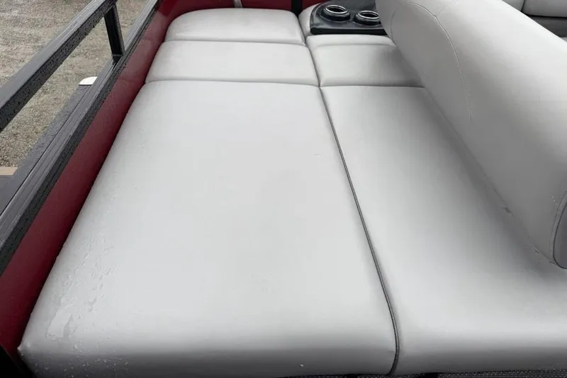 Slide: The Image of 2023 Regency 250 DL3 boat interior with white cushioned seating and cup holders. - 19