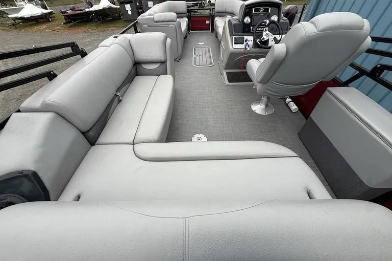 Slide: The Image of 2023 Regency 250 DL3 pontoon boat interior with plush seating and modern helm. - 22
