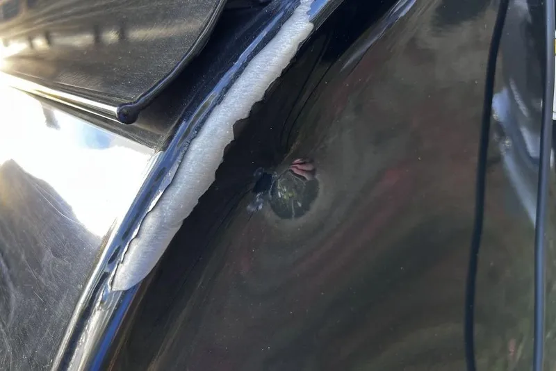 Slide: The Image of Damaged hull of 2023 Regency 250 DL3 boat with visible crack and dent. - 26