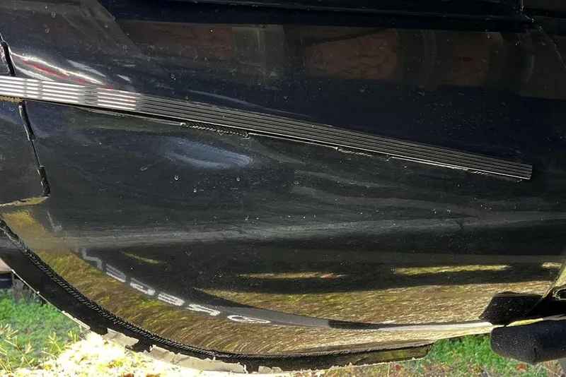 Slide: The Image of 2023 Regency 250 DL3 boat hull with visible scratches and reflections. - 29