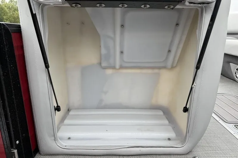 Slide: The Image of Open storage compartment in a 2023 Regency 250 DL3 boat. - 3