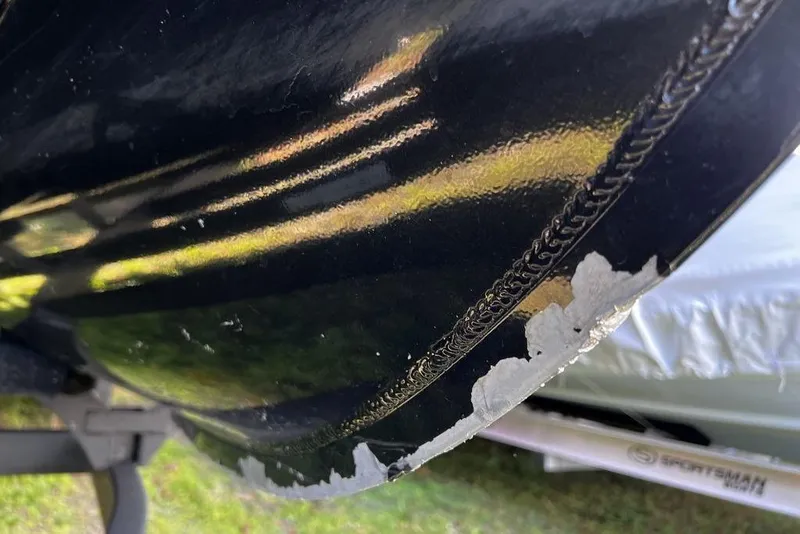 Slide: The Image of Close-up of damaged paint on 2023 Regency 250 DL3 boat hull. - 30