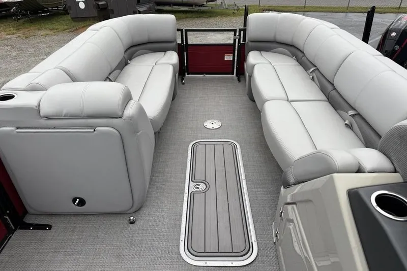 Slide: The Image of 2023 Regency 250 DL3 pontoon boat interior with plush gray seating and modern flooring. - 36