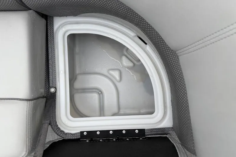 Slide: The Image of Storage compartment in 2023 Regency 250 DL3 boat, featuring a white interior and gray upholstery. - 37