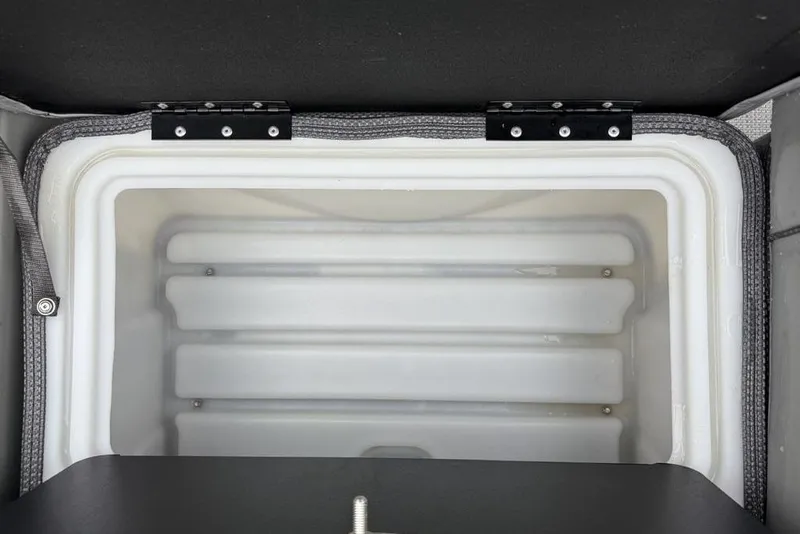 Slide: The Image of Open storage compartment in 2023 Regency 250 DL3 boat, featuring a white interior and secure hinges. - 40