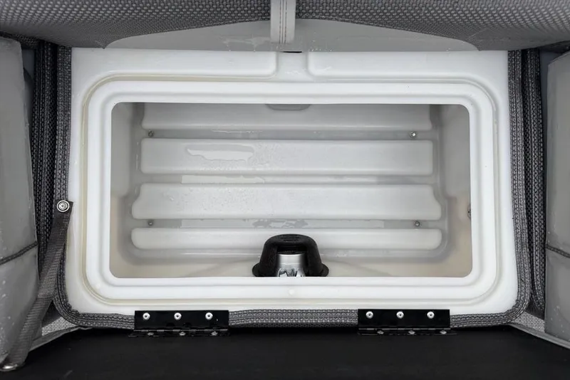 Slide: The Image of 2023 Regency 250 DL3 boat cooler compartment, open and empty, with gray upholstery. - 41
