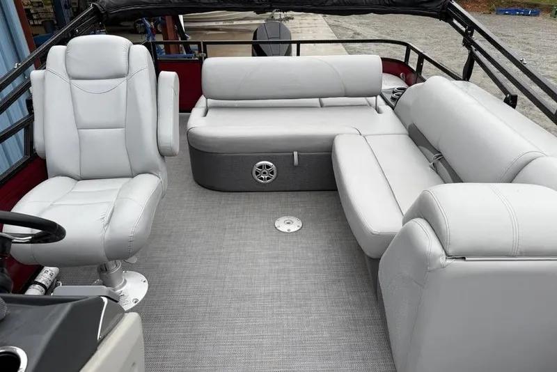 Slide: The Image of 2023 Regency 250 DL3 pontoon boat interior with gray seating and flooring. - 6