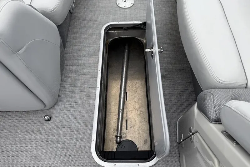 Slide: The Image of Open storage compartment on 2023 Regency 250 DL3 boat with gray seating. - 7