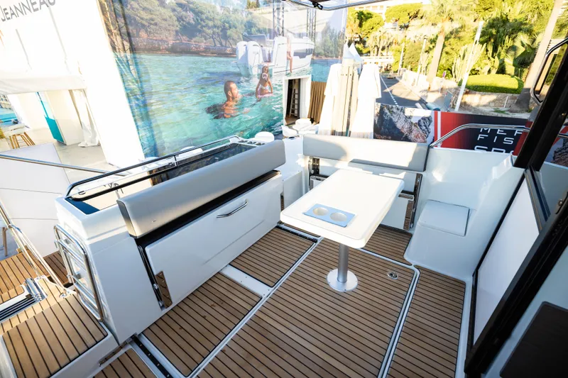 Slide: The Image of 2026 Jeanneau NC 895 Sport Series 2 boat interior with sleek seating and table. - 15
